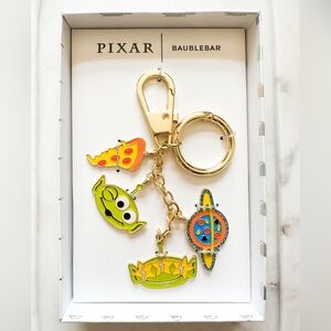 BaubleBar Pixar Keychain with Gold and Green Accents